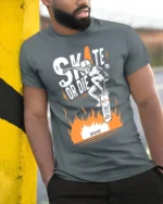 Skate or Die T-Shirt Cool Skull Fire Skater Graphic - model in grey shirt leaning against column