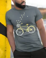 Starry Bicycle Ride T-Shirt Dreamy Bike Graphic - model in grey shirt leaning against column