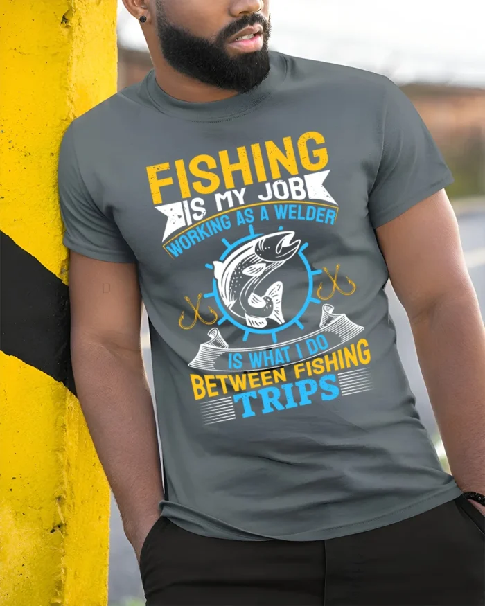Fishing Is My Job T-Shirt Welder Between Fishing Trips - model in grey shirt leaning against column