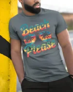 Beach Please Funny Sunset Graphic T-Shirt for Vacation - model in grey shirt leaning against column