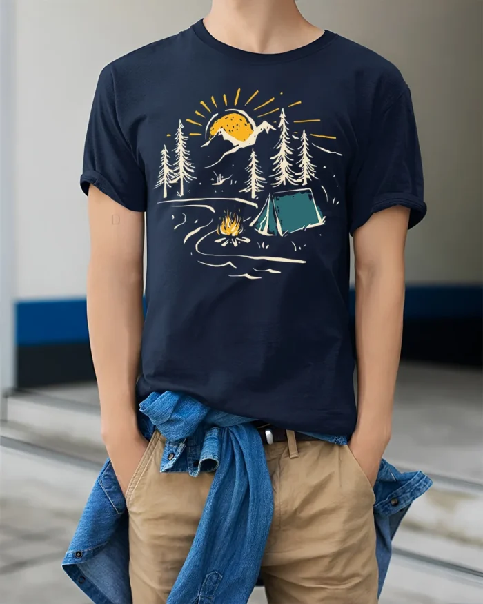 Sunset Camping Scene T-Shirt Cozy Campfire Forest Tee - model wearing navy shirt, hands in pockets