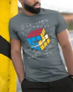 Math Puzzle Cube T-Shirt Nerdy Graphic Tee for Thinkers - model in grey shirt leaning against column