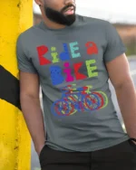 Ride a Bike T-Shirt Colorful Cycling Graphic Tee - model in grey shirt leaning against column