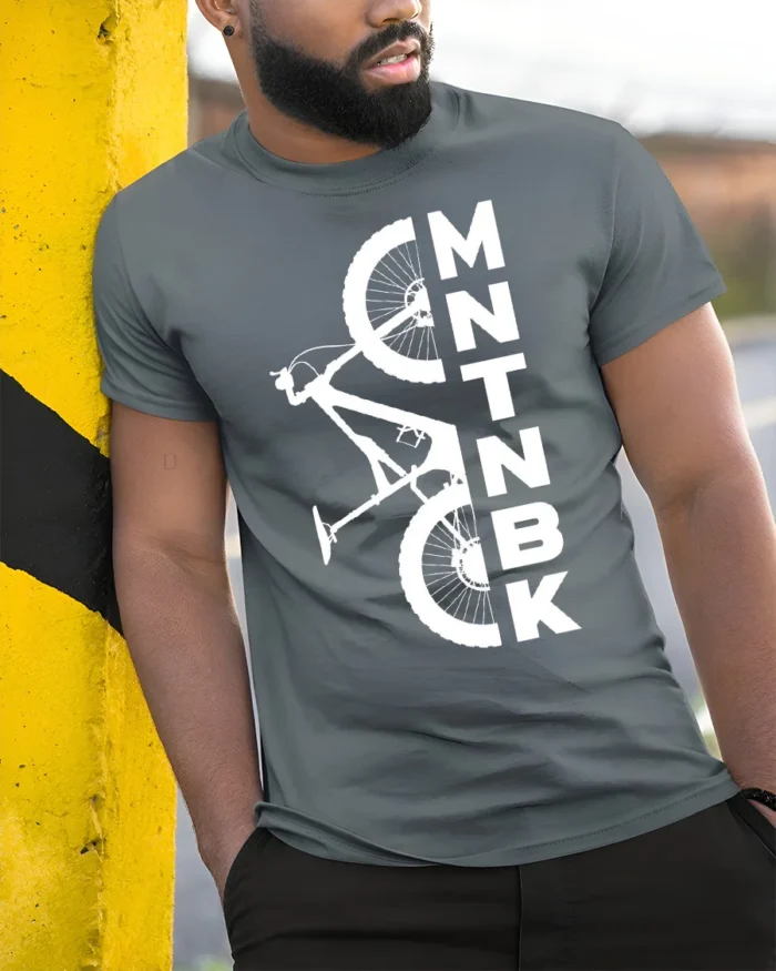 MTNBK Mountain Bike T-Shirt Bold MTB Graphic Tee - model in grey shirt leaning against column
