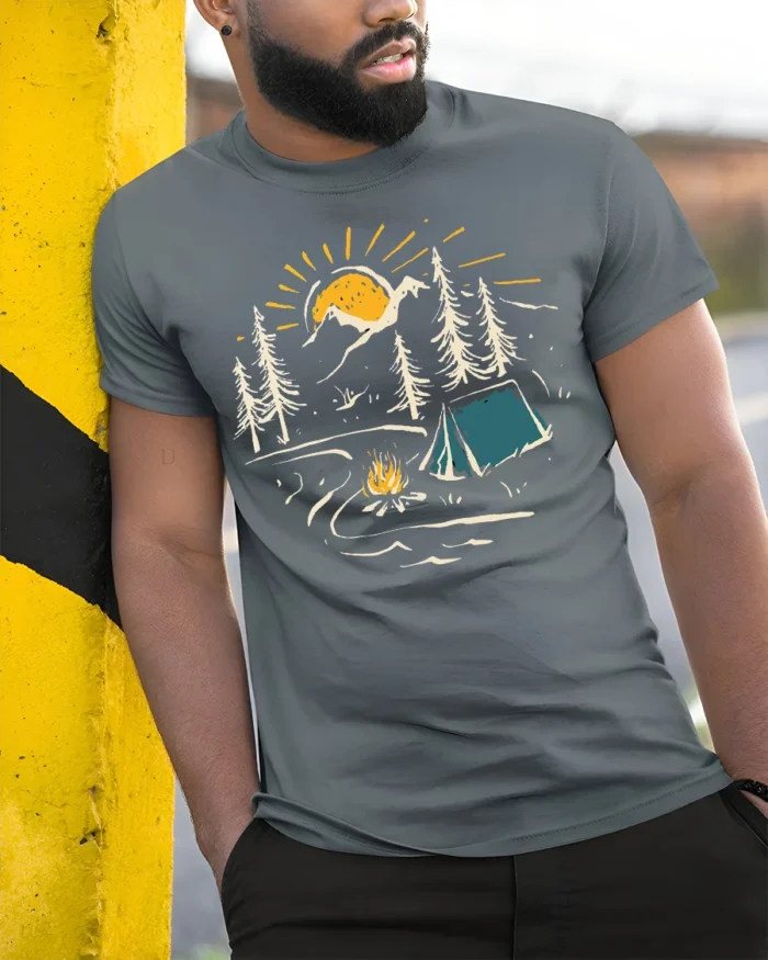 Sunset Camping Scene T-Shirt Cozy Campfire Forest Tee - model in grey shirt leaning against column