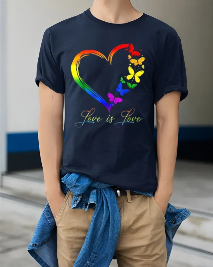 Love is Love Rainbow Heart Pride T-Shirt with Butterflies - model wearing navy shirt, hands in pockets