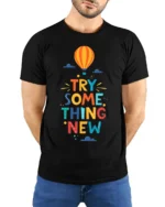 Try Something New T-Shirt Motivational Hot Air Balloon - model wearing black shirt, hands behind back