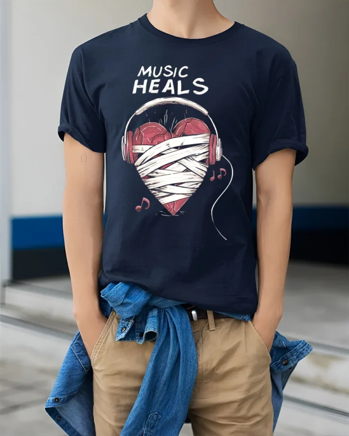 Music Heals T-shirt with Heart Headphones Design - model wearing navy shirt, hands in pockets