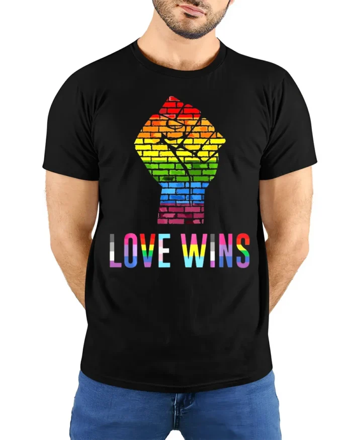 Love Wins Rainbow Pride Fist T-Shirt LGBTQ Equality - model wearing black shirt, hands behind back