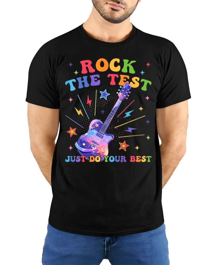 Rock the Test T-shirt Rainbow Guitar Motivational - model wearing black shirt, hands behind back