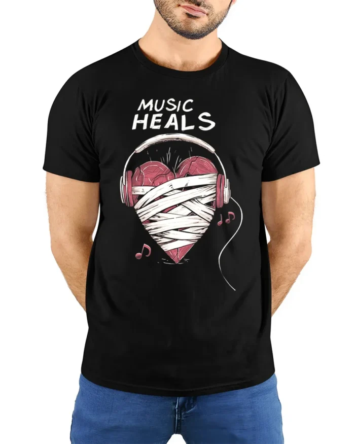 Music Heals T-shirt with Heart Headphones Design - model wearing black shirt, hands behind back