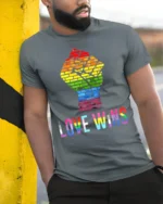Love Wins Rainbow Pride Fist T-Shirt LGBTQ Equality - model in grey shirt leaning against column