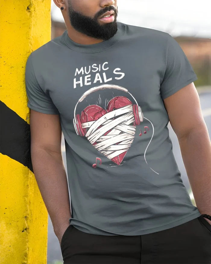 Music Heals T-shirt with Heart Headphones Design - model in grey shirt leaning against column