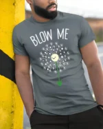 Funny Blow Me Dandelion Graphic T-Shirt for Adults - model in grey shirt leaning against column