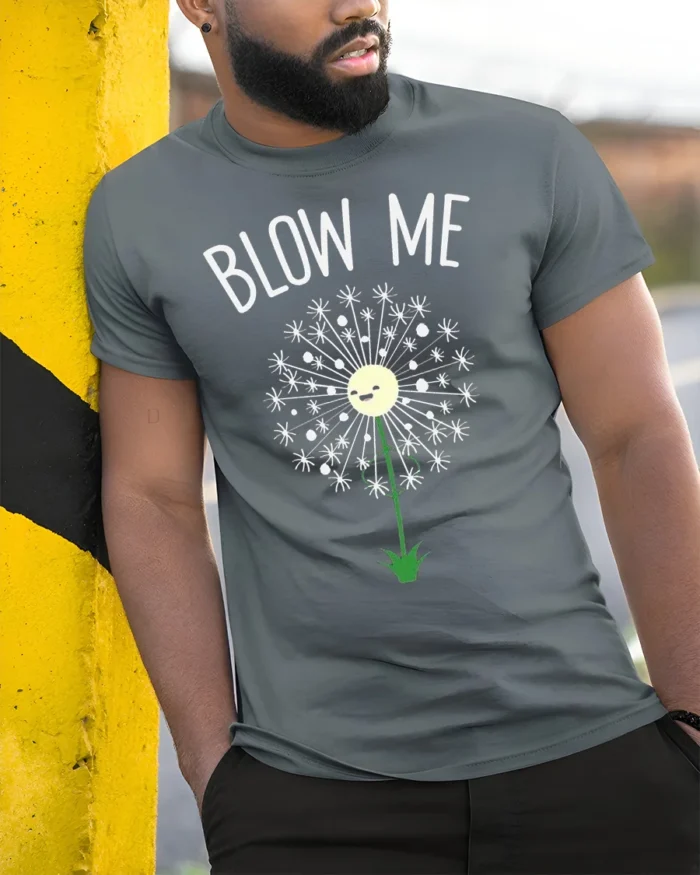 Funny Blow Me Dandelion Graphic T-Shirt for Adults - model in grey shirt leaning against column