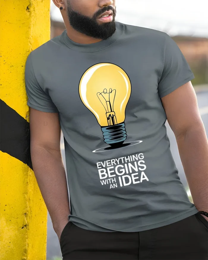 Everything Begins With an Idea Light Bulb T-Shirt - model in grey shirt leaning against column