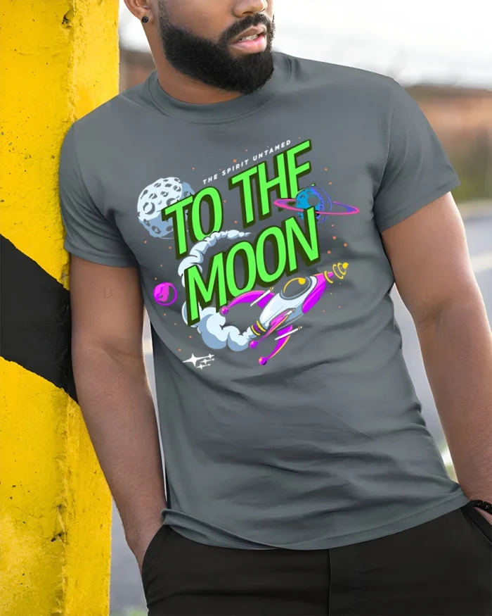 To The Moon T-Shirt Retro Space Rocket Graphic - model in grey shirt leaning against column