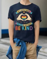 Be Kind Rainbow Heart Pride T-Shirt with Positive Message - model wearing navy shirt, hands in pockets