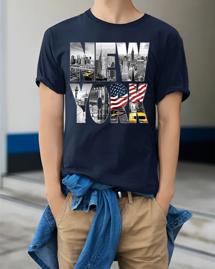 New York City Skyline T-Shirt with Statue and Flag Design - model wearing navy shirt, hands in pockets