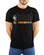 Astronaut Swinging on Planets Funny Space T-Shirt for Adults - model wearing black shirt, hands behind back