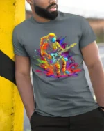 Astronaut Guitar Blast Graphic T-Shirt for Music Lovers - model in grey shirt leaning against column