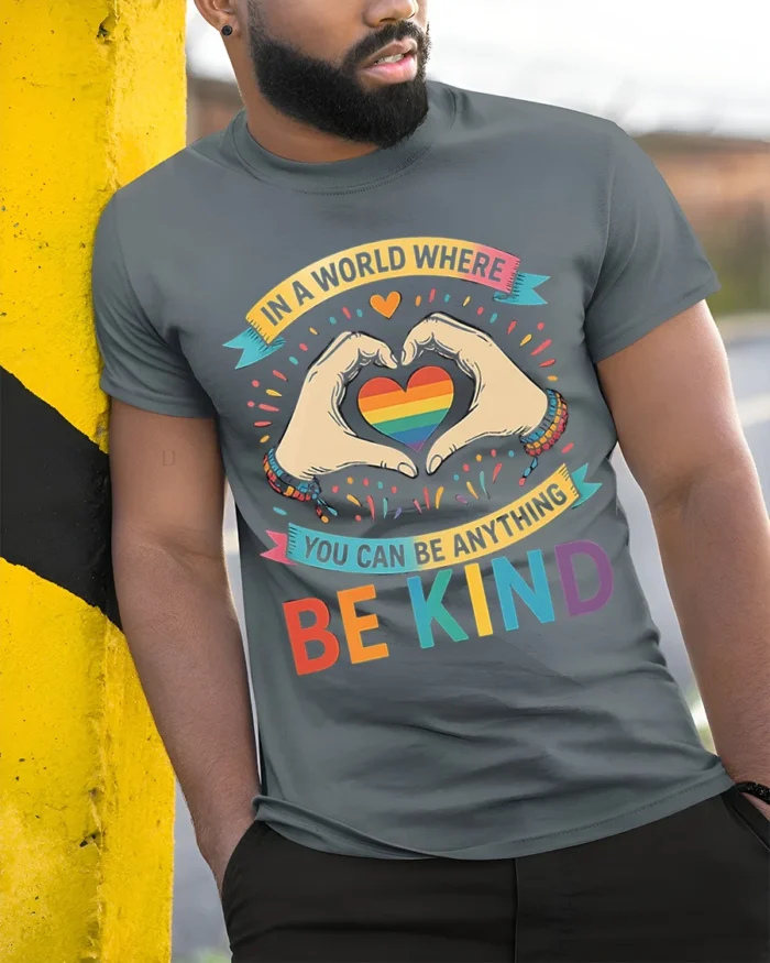 Be Kind Rainbow Heart Pride T-Shirt with Positive Message - model in grey shirt leaning against column