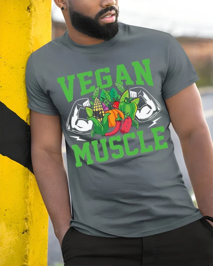 Vegan Muscle T-Shirt with Bold Veggie and Fitness Design - model in grey shirt leaning against column