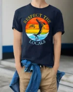 Respect the Locals T-Shirt Ocean Wildlife Sunset - model wearing navy shirt, hands in pockets