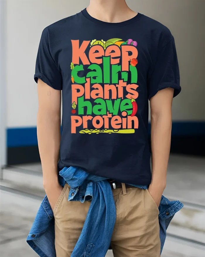 Keep Calm Plants Have Protein T-Shirt Vegan Message - model wearing navy shirt, hands in pockets