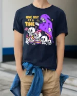 One Day at a Time Skeleton T-Shirt Grim Reaper Graphic - model wearing navy shirt, hands in pockets