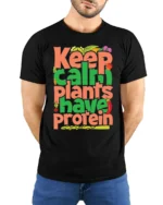 Keep Calm Plants Have Protein T-Shirt Vegan Message - model wearing black shirt, hands behind back