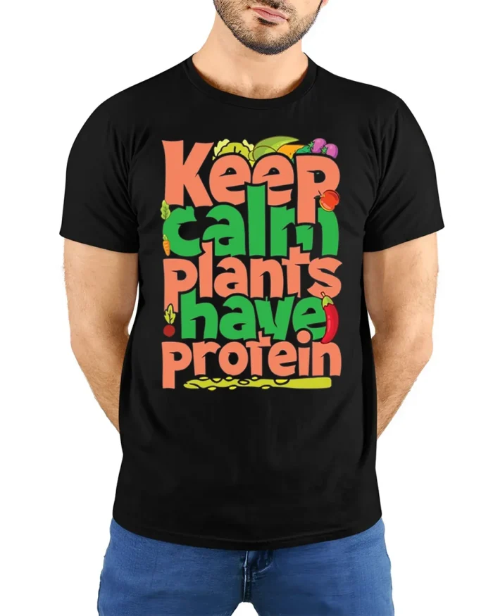 Keep Calm Plants Have Protein T-Shirt Vegan Message - model wearing black shirt, hands behind back