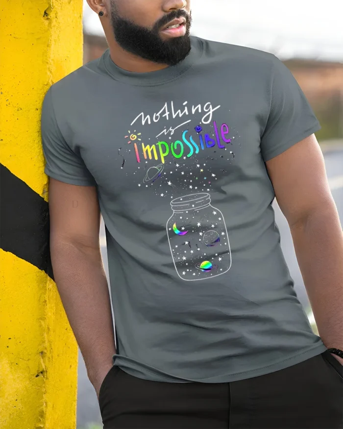 Nothing Is Impossible Rainbow Galaxy T-Shirt for Dreamers - model in grey shirt leaning against column