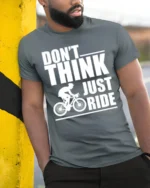 Don’t Think Just Ride Cycling T-Shirt Biker Motivation - model in grey shirt leaning against column