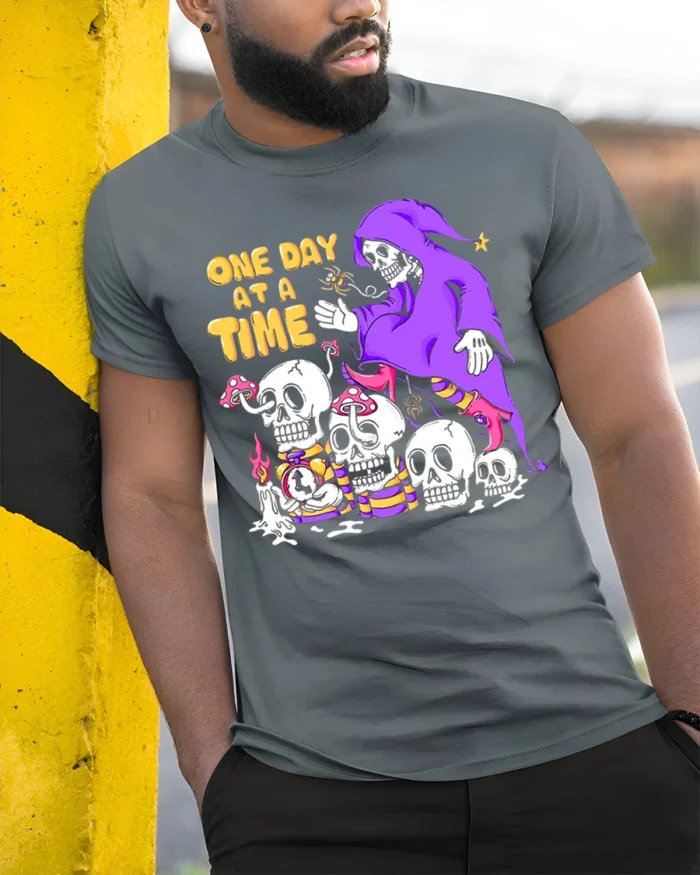 One Day at a Time Skeleton T-Shirt Grim Reaper Graphic - model in grey shirt leaning against column