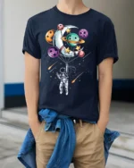 Astronaut Floating with Planet Balloons Space Art T-Shirt - model wearing navy shirt, hands in pockets
