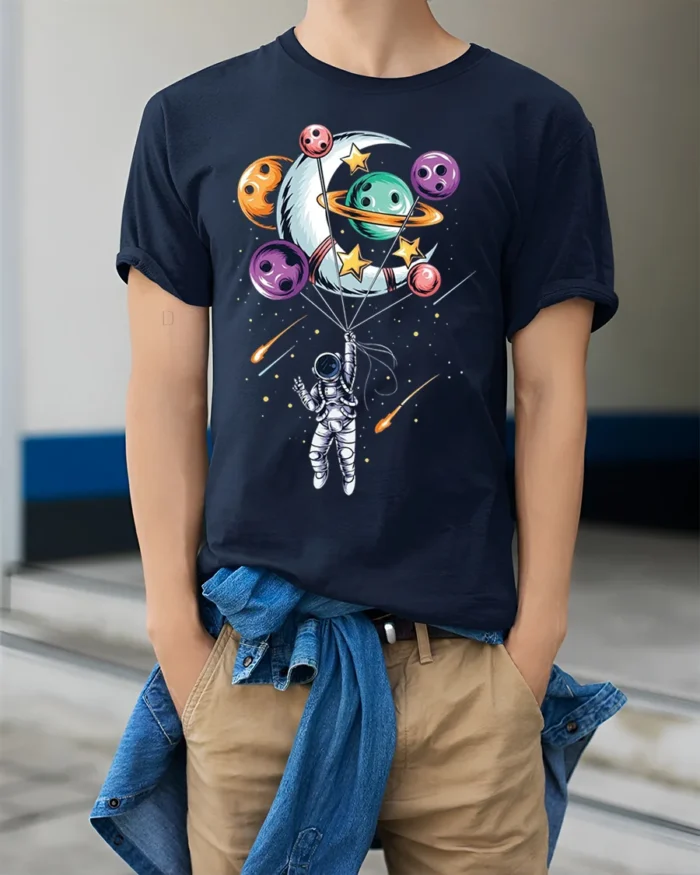 Astronaut Floating with Planet Balloons Space Art T-Shirt - model wearing navy shirt, hands in pockets