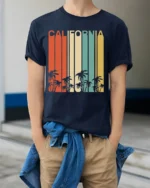 Retro California T-Shirt Vintage Sunset Palm Tree - model wearing navy shirt, hands in pockets