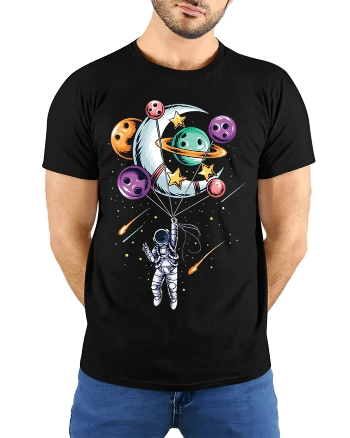 Astronaut Floating with Planet Balloons Space Art T-Shirt - model wearing black shirt, hands behind back