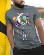 Astronaut Floating with Planet Balloons Space Art T-Shirt - model in grey shirt leaning against column