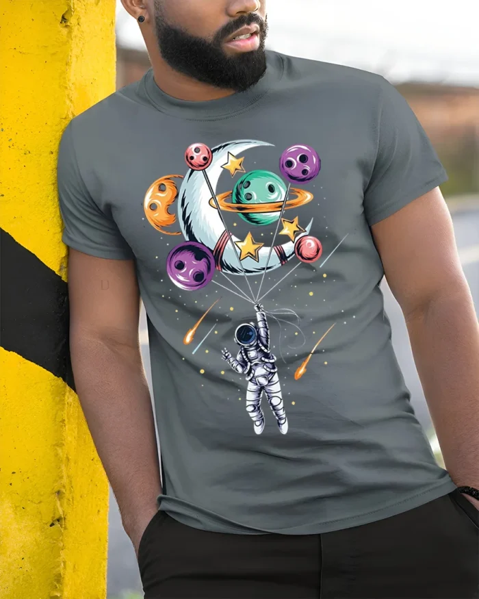 Astronaut Floating with Planet Balloons Space Art T-Shirt - model in grey shirt leaning against column