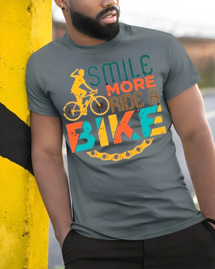 Smile More Ride A Bike Colorful Cyclist Graphic T-Shirt - model in grey shirt leaning against column