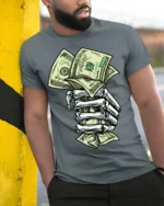 Skeleton Hand Money T-Shirt Street Hustle Graphic Tee - model in grey shirt leaning against column