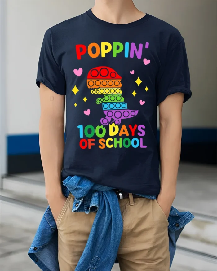 Colorful Dino Pop It 100 Days School T-Shirt - model wearing navy shirt, hands in pockets