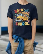 Back to School T-Shirt with Fun Yellow School Bus Print - model wearing navy shirt, hands in pockets