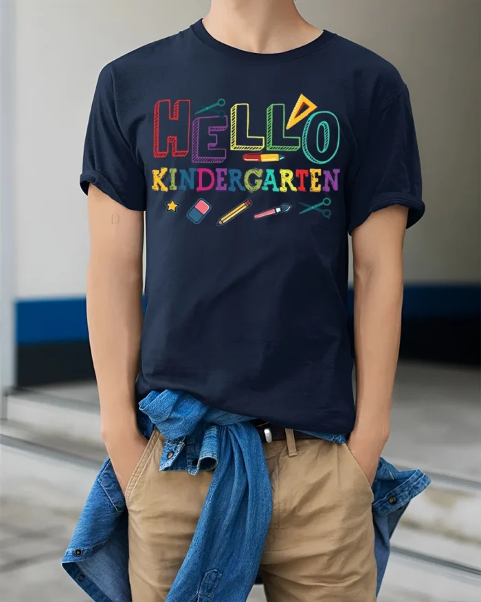 Hello Kindergarten Rainbow School Supplies T-Shirt - model wearing navy shirt, hands in pockets
