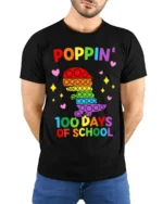 Colorful Dino Pop It 100 Days School T-Shirt - model wearing black shirt, hands behind back