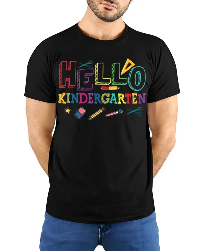 Hello Kindergarten Rainbow School Supplies T-Shirt - model wearing black shirt, hands behind back