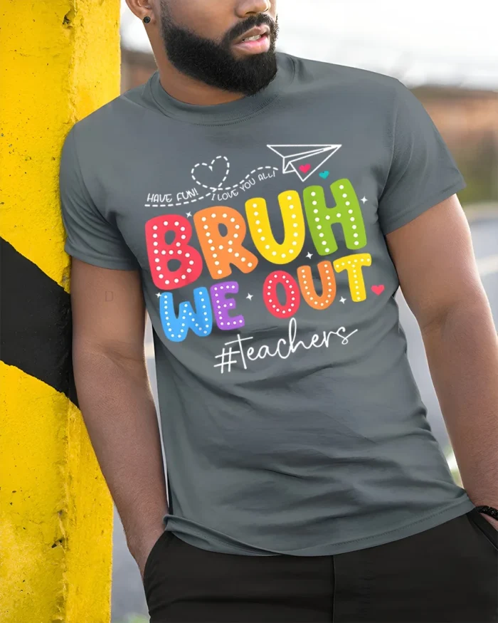 Funny Teacher Bruh We Out T-Shirt for Last Day Vibes - model in grey shirt leaning against column