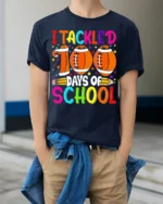 I Tackled 100 Days of School Football T-Shirt - model wearing navy shirt, hands in pockets